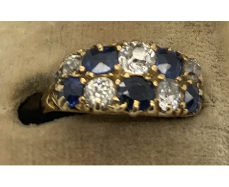 A diamond and sapphire lady's dress ring in 18ct gold. Size K/L. 4gms.Good condition.