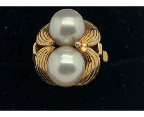 An 18ct gold ring set with two cultured pearls. Size L/M. 6.2gms total weight.Condition ReportGood condition.
