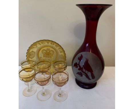 An etched ruby glass vase, 35cms h, 6 coloured and gilt glasses and a Queen Victoria moulded glass jubilee plate.Condition Re