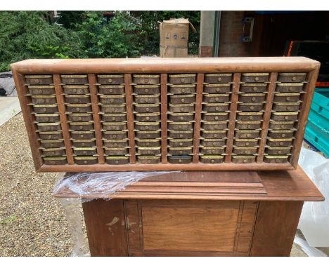 A tobacco tin shelf unit. 89cms w x 37cms h x 12cms d.Condition ReportWear to wood and holes to back and some rust to tins.