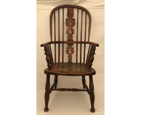 A Windsor oak stick back armchair, height to seat 39cms, to back 100cms, width 53cms.Condition ReportSplits in wood to seat, 