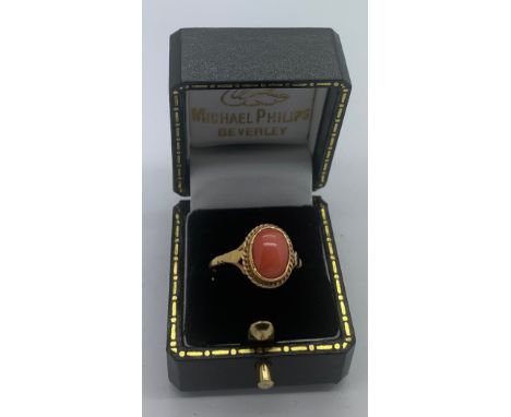 A 9ct gold lady's dress ring set with single coral stone. Size N/O.Condition ReportGood condition.