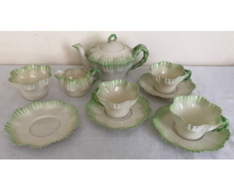 A Belleek green and cream part tea service with rope twist handles comprising teapot 12cms h, sugar bowl, cream jug, 4 saucer