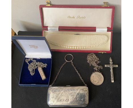 A miscellany to include a silver ingot on a chain, purse with finger ring, a mounted 1923 dollar on a chain, white metal cruc