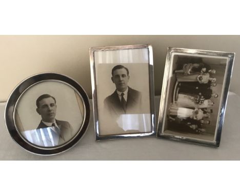Three hallmarked silver photo frames. Circular frame with tortoiseshell 13cms w, Sanders and Mackenzie, Birmingham 1919. Rect