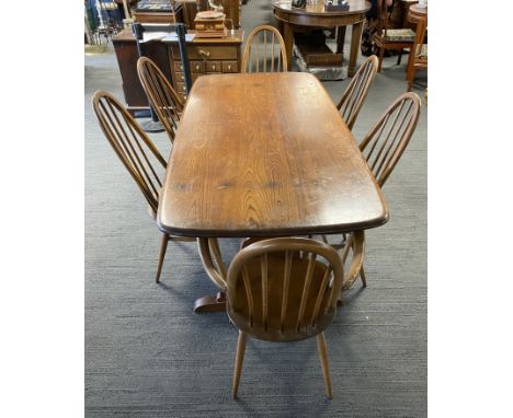 A mid century possibly Ercol mid brown refectory dining table with 6 chairs, 4 dining and 2 carvers. Table measures 183 l x 8