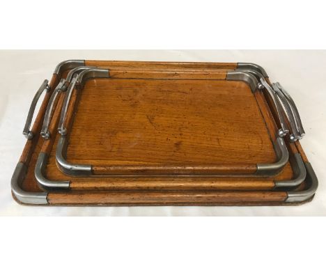 A graduating set of 3 art deco oak trays with chrome mounts and handles. Largest tray 49cms w x 36cms l.Condition ReportVarni