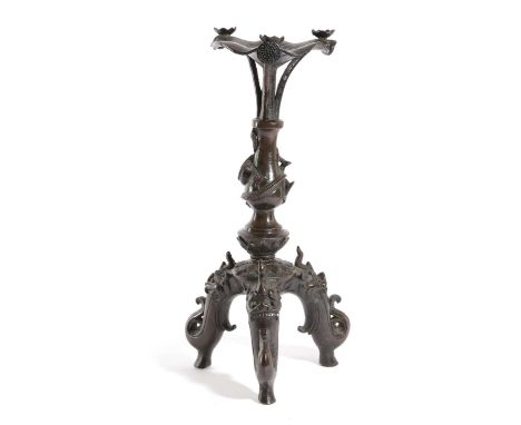 A CHINESE BRONZE TRIPOD CANDLESTICKIN MING STYLE, 19TH CENTURYthe lotus-shaped drip pan above a baluster column with a twisti