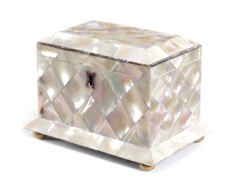 AN EARLY VICTORIAN MOTHER OF PEARL TEA CADDYc.1840of sarcophagus form, the hinged cover with abalone banding enclosing a sing