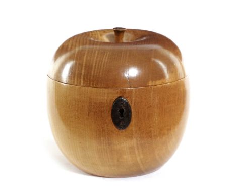 A TREEN FRUITWOOD TEA CADDY IN THE FORM OF AN APPLEPROBABLY GERMAN, C. 1800with a stalk finial, a steel oval escutcheon and t