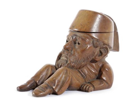 A BLACK FOREST LINDEN WOOD FIGURAL INKWELL LATE 19TH CENTURYhis hat hinged revealing a ceramic well13.5cm wide