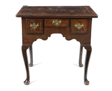 A GEORGE II WALNUT LOWBOYC.1735-40inlaid with boxwood and ebonised stringing, the quarter veneered caddy moulded top above th