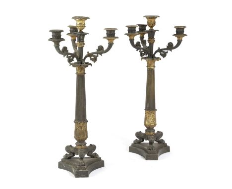 A PAIR OF REGENCY GILT AND PATINATED BRONZE CANDELABRAIN EMPIRE STYLE, EARLY 19TH CENTURYeach with a central urn shaped nozzl