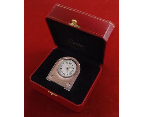 Cartier travel alarm clock, the signed circular silvered dial with Roman numerals, outer minute track and alarm indicator, do