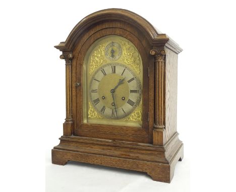 Oak three train bracket clock, the Gustav Becker movement playing on five rods, the 7" brass arched dial with strike/silent d