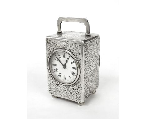 Edwardian silver cased carriage clock timepiece, the 2" white dial within a C-scroll and foliate engraved case surmounted by 
