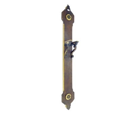 Long oak wall clock bracket board, applied to the shaped top and bottom with carved gilt flowerheads and fitted with 7" deep 
