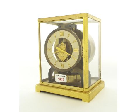 Jaeger-LeCoultre Atmos clock, the 4.25" white chapter ring enclosing a skeletonised centre, within a brushed brass glazed cas