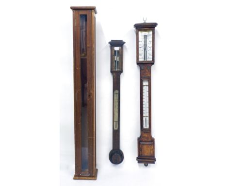 Oak cased stick barometer/thermometer, the angled scales over a flat trunk and rectangular stepped cistern cover; also anothe