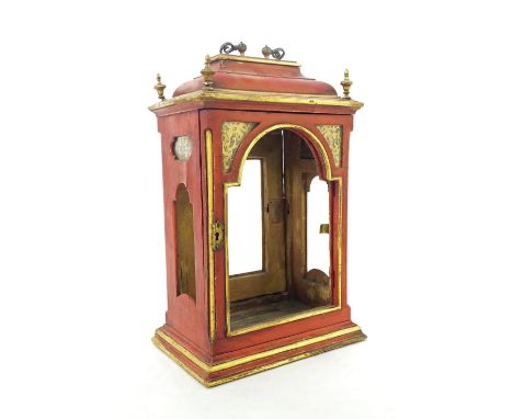 Antique red lacquer bracket clock case with aperture for an 8" arched dial, surmounted by a caddy top and ornate brass carryi