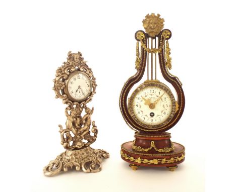 Attractive brass and painted wooden lyre mantel clock timepiece, 10.5" high; also an ornate white metal watch stand with pock
