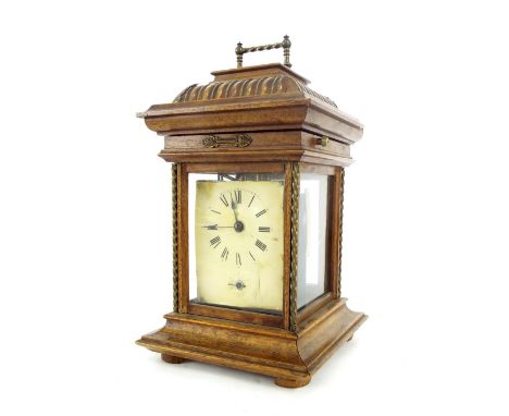 Oak cased symphonium clock with alarm, the dial plate within a four glass case surmounted by a hinged lid opening to reveal t