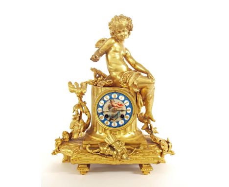 French gilt metal two train figural mantel clock striking on a bell, the 3.25" porcelain dial inset into a fluted pillar surm
