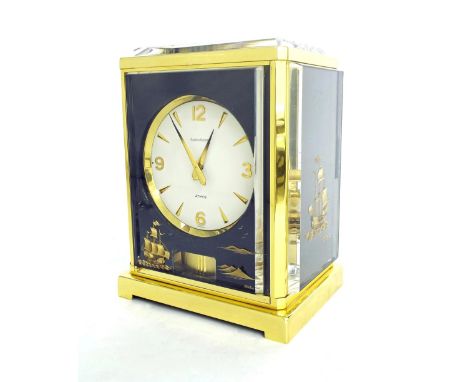 Jaeger-LeCoultre Atmos clock, the 4.25" white dial within a brass bound case with raised panels decorated with sailing vessel