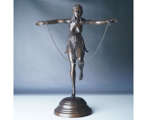 This Art Deco bronze figurine, crafted in the style of Demetre Chiparus, depicts a graceful "Chain Dancer" adorned with a cha