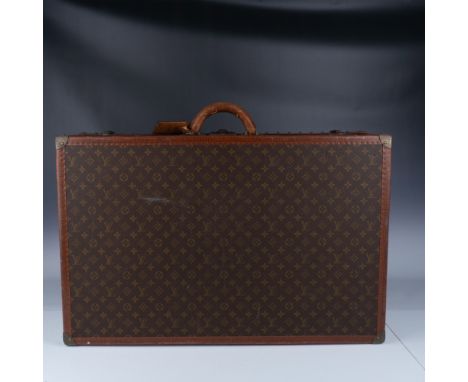 Vintage Louis Vuitton monogram canvas hard-sided suitcase, featuring the iconic LV monogram design, reinforced leather trim, 