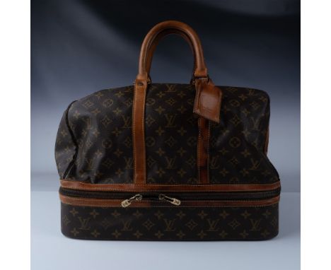 This Louis Vuitton Monogram Canvas Sac Sports Boston Bag is a classic and versatile piece from one of the world's most iconic
