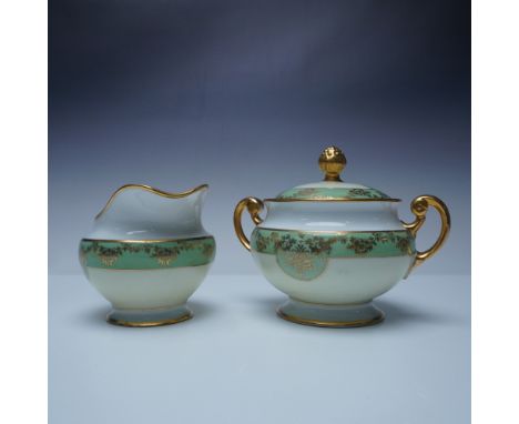 Elegant Hutschenreuther Bavaria porcelain creamer (4") and lidded sugar bowl (5.5") set featuring a refined green and gold fl