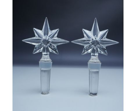 A set of two crystal bottle stoppers by Waterford, designed as part of the Congratulations series. Each stopper features a ra