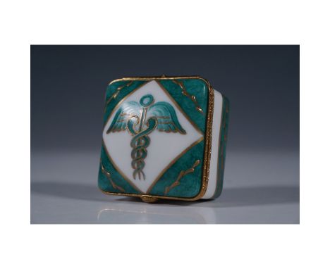 Exquisite Limoges France porcelain trinket box featuring a detailed caduceus symbol in gold relief against a rich green and w