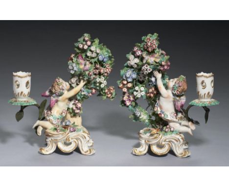 A PAIR OF BOW 'CUPID CATCHING A BIRD' BOCAGE CANDLESTICKS, C1770  22cm h, red enamel anchor and dagger or unmarked++Old overp