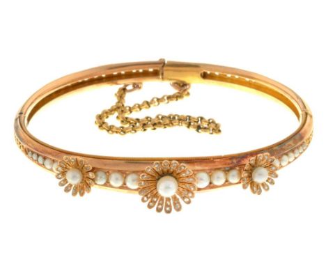 A CULTURED PEARL AND DIAMOND BANGLE with old cut diamonds, guilloche set in gold, 65mm, unmarked, 20.1g++Good condition