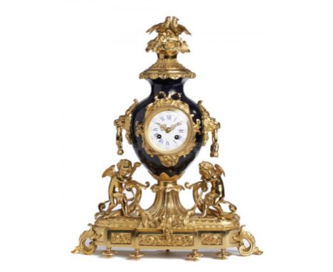 A FRENCH  GILT BRASS AND SÈVRES STYLE BLUE GLAZED VASE SHAPED MANTEL CLOCK   in Louis XVI style,  having lion mask handles, o