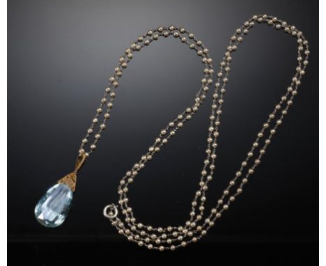 A FINE AQUAMARINE PENDANT AND CULTURED PEARL CHAIN the briolette aquamarine 36 x 20mm, gold filigree mount, chain 150cm l, un