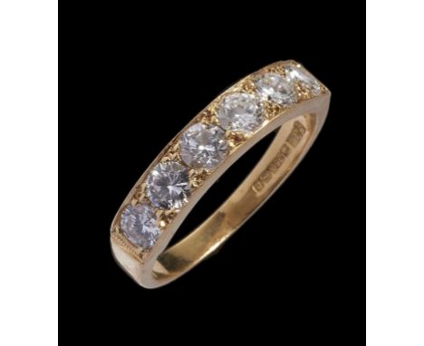 A DIAMOND RING with a line of six round brilliant cut diamonds weighing in total approx 1.2ct, in 18ct gold, Birmingham 1985,