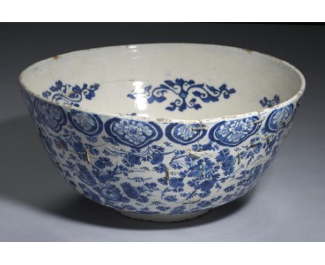 A DUTCH DELFTWARE PUNCH BOWL, 18TH C  painted with stylised flowers beneath ruyi border, painted monogram /1/0/GK++Broken and