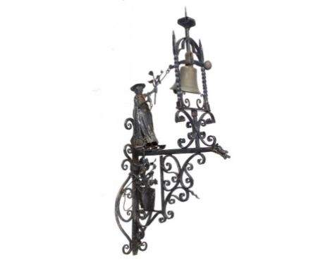 A WROUGHT  IRON FIGURAL WALL BELL, FIRST HALF 20TH C  the brass bell in arched frame, the counter balanced pull threaded thro