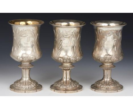 THE HENLEY ROYAL REGATTA SILVER GOBLETS.  THREE ELIZABETH  II ROWING PRIZES  chased with lilies and rushes, inscribed THE SIL