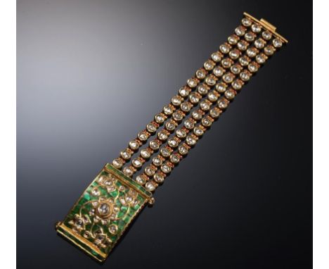 AN INDIAN DIAMOND, GOLD AND TRANSLUCENT ENAMEL BRACELET, LATE 19TH C the reverse with a brrd and tendrils, 170mm, unmarked, 1