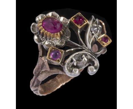 A RUBY AND DIAMOND FLOWER RING in gold and white gold with chased shoulders, unmarked, 5g, size M++Good condition