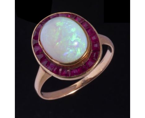 AN OPAL AND RUBY CLUSTER RING in gold, unmarked, 3.75g, size M++Opal is slightly loose in setting, reasonable polish