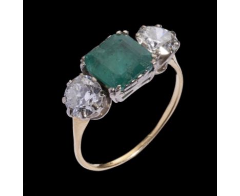 AN EMERALD AND DIAMOND THREE STONE RING the cushion cut emerald 8 x 8mm between round brilliant cut diamonds weighing approx 