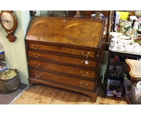George III mahogany four drawer bureau on shell inlaid bracket feet
