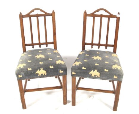 Pair of 19th century Gothic Revival style pitch pine stick back chairs. With 'Elephant &amp; Castle' design upholstered padde