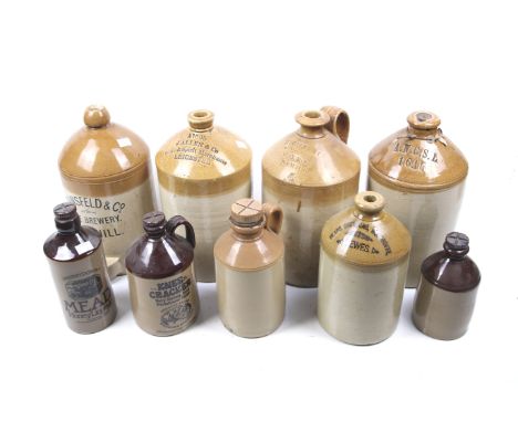 A collection of vintage saltglazed stoneware bottles. Including four cider flagons, one marked 'J. Allen & Co' and another 'S