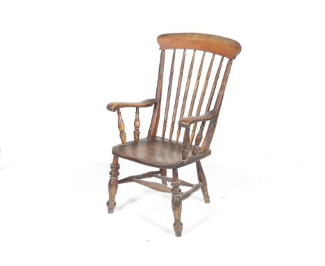 Antique stick back fireside Windsor armchair. With stick and bar back, above moulded shaped elm saddle seat, raised on four t